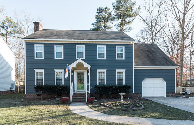 blue house exterior remodel with James Hardie Siding