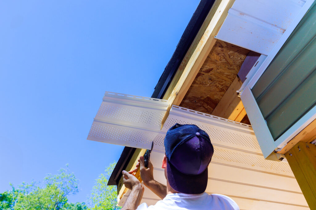 Representative of company installed vinyl soffit plastic panels on facade ceiling new house